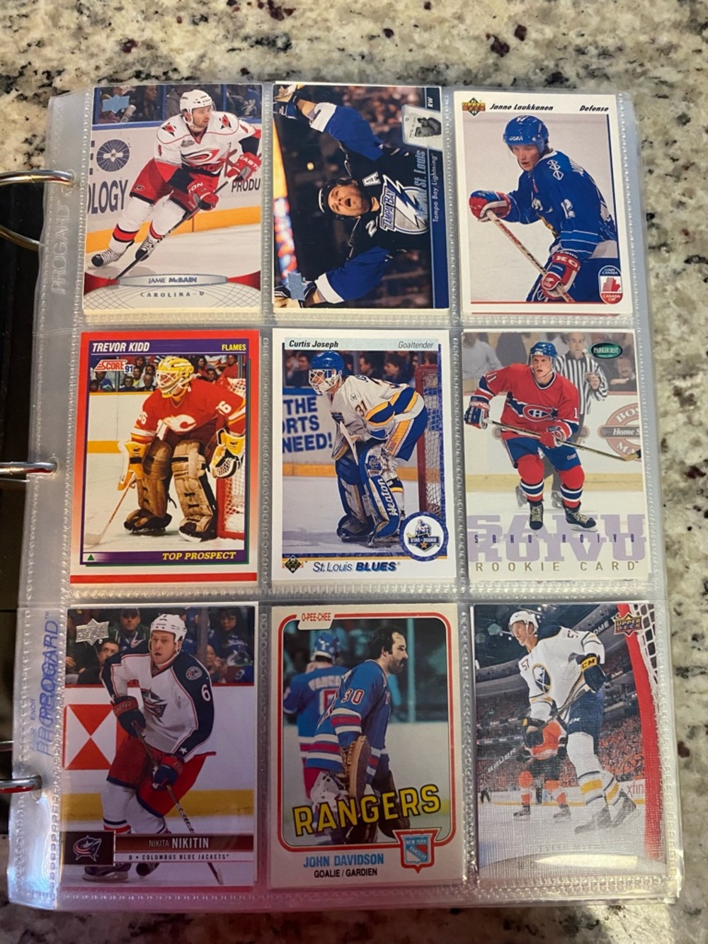 Binder full of hockey cards with stars and young guns